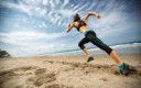 girl-wearing-sportswear-ready-to-start-running-on-beach.jpg