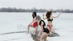 stock-footage-beautiful-women-in-swimsuits-frolic-in-the-ic[...].mp4