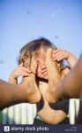 male-toddler-with-face-against-mothers-bare-feet-J3Y76A.jpg