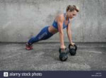 young-muscular-girl-doing-push-ups-from-the-floor-and-leani[...].jpg
