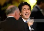 japanese-prime-minister-shinzo-abe-laughs-after-offering-a-[...].jpg