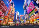 stock-photo-tokyo-japan-august-crowds-pass-below-colorful-s[...]