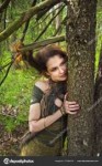depositphotos177369776-stock-photo-forest-witch-hugging-tree.jpg