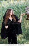 stock-photo-young-beautiful-witch-with-an-owl-in-the-forest[...].jpg