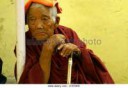 old-tibetan-monk-woman-sitting-leaned-over-a-tube-support-i[...].jpg