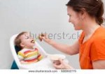 stock-photo-mum-spoon-feeds-the-baby-in-kitchen-588802775