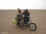 Mongolie-Mongolia-Desert steppe riders on motocycle.jpg
