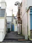 narrow-street-back-alley-restaurant-air-ventilation-duct-one-plastic-wheelie-bin-muted-white-grey-color-266709475.jpg