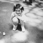 A young Jewish girl who is living in hiding in German-occupied France, plays outside with a toy..jpeg