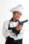 14233224-an-asian-woman-as-restaurant-chef-with-a-gun-in-th[...].jpg
