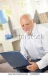 stock-photo-smiling-elderly-man-looking-at-laptop-computer-[...].jpg