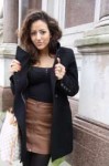 divine girl in coat leather skirt tights.jpg