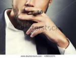 stock-photo-close-up-hand-of-bearded-caucasian-man-smoking-[...].jpg