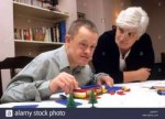 down-syndrome-young-man-with-teacher-building-lego-blocks-D[...].jpg