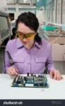 stock-photo-beautiful-woman-repair-soldering-a-printed-circ[...].jpg