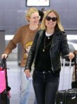 olivia-wilde-and-elle-fanning-share-a-laugh-arriving-at-jfk[...].jpg