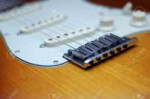 2580356-close-up-of-a-fender-american-deluxe-guitar-bridge.jpg