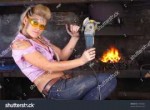 stock-photo-attractive-girl-in-workshop-with-instrument-in-[...].jpg