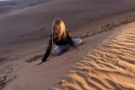 girl-sitting-desert-dunes-young-top-sand-dune-sandboarding-[...].jpg