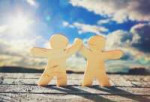 46651308-wooden-little-men-holding-hands-on-sky-and-sun-bac[...].jpg