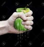 7086306-hand-to-squeeze-a-green-apple-isolated-in-black-bac[...]